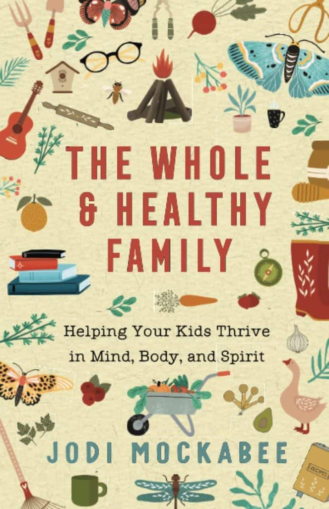 Cover for "The Whole and Healthy Family" by Jodi Mockabee. The cover features a beige backgorund with gardening implements, animals, instruments, and camping gear in the foreground, surrounding the title.