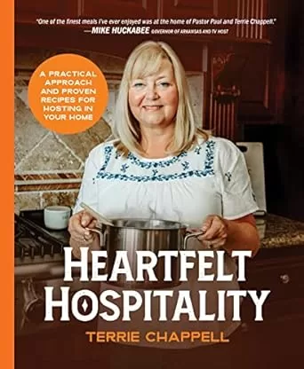 The book cover for "Heartfelt Hospitality" by Terrie Chappell. It shows Terry holding a large pot presumably full of food. She is in her kitchen and smiling at the viewer.
