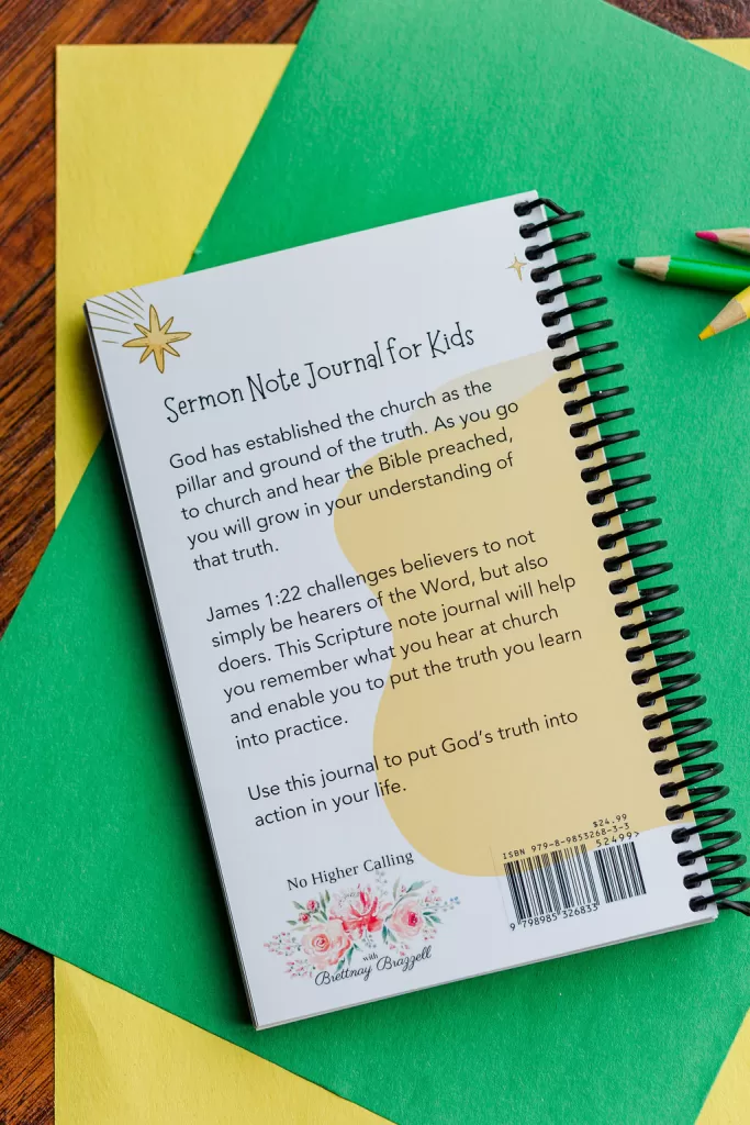The back side of the sermon note journal showing the descriptive text. It is laying on green and yellow paper with colored pencils