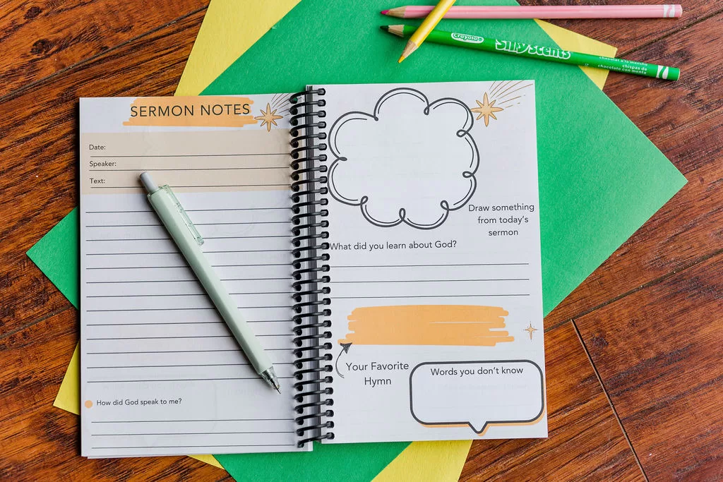 The Sermon Note Journal laying open. Displayed are pages which prompt kids to take notes as well as give some info about their favorite portions of the service